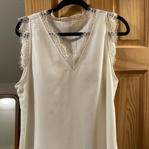 Sleeveless white top with lace detail